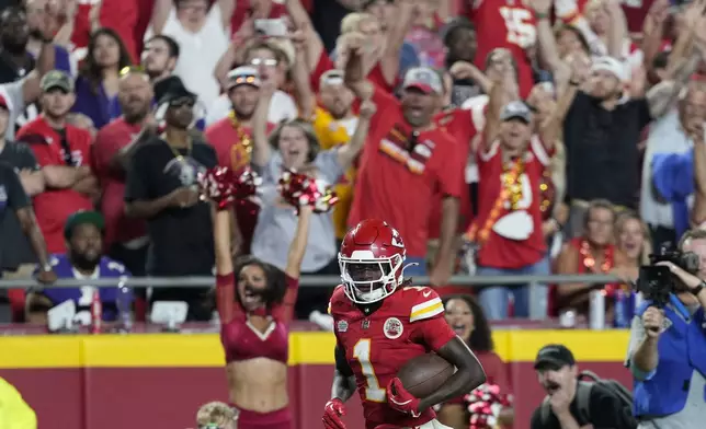 Kansas City Chiefs wide receiver Xavier Worthy heads for the end zone after catching a 35-yard pass for a touchdown during the second half of an NFL football game against the Baltimore Ravens Thursday, Sept. 5, 2024, in Kansas City, Mo. (AP Photo/Ed Zurga)