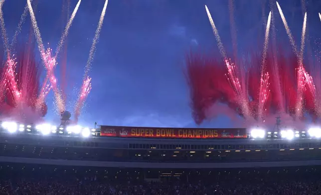 Fireworks fill the sky over Arrowhead Stadium as the Kansas City Chiefs' Super Bowl XVIII championship banner is unveiled before the start of an NFL football game between the Chiefs and the Baltimore Ravens Thursday, Sept. 5, 2024, in Kansas City, Mo. (AP Photo/Ed Zurga)