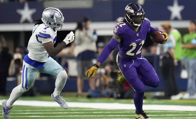 Baltimore Ravens running back Derrick Henry (22) runs the ball as Dallas Cowboys cornerback Trevon Diggs (7) gives chase in the second half of an NFL football game in Arlington, Texas, Sunday, Sept. 22, 2024. (AP Photo/Julio Cortez)