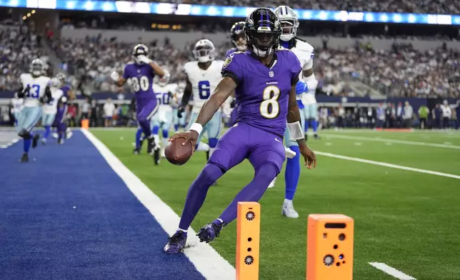 Baltimore Ravens quarterback Lamar Jackson (8) runs the ball for a touchdown against the Dallas Cowboys in the first half of an NFL football game in Arlington, Texas, Sunday, Sept. 22, 2024. (AP Photo/Julio Cortez)