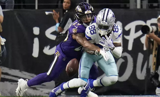 Baltimore Ravens safety Ar'Darius Washington (29) breaks up a pass intended for Dallas Cowboys wide receiver CeeDee Lamb (88) in the second half of an NFL football game in Arlington, Texas, Sunday, Sept. 22, 2024. (AP Photo/Julio Cortez)