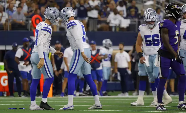 Dallas Cowboys' Brandon Aubrey, left, and Bryan Anger, second from right, celebrate after Aubrey kicked a 65-yard field goal against the Baltimore Ravens in the first half of an NFL football game in Arlington, Texas, Sunday, Sept. 22, 2024. (AP Photo/Gareth Patterson)