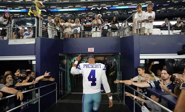 Dallas Cowboys quarterback Dak Prescott walks off the field past fans after the team's NFL football game against the Baltimore Ravens in Arlington, Texas, Sunday, Sept. 22, 2024. (AP Photo/Jeffrey McWhorter)