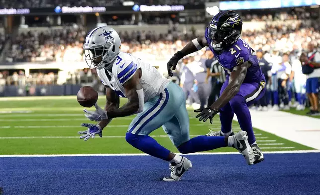Dallas Cowboys wide receiver Brandin Cooks (3) is uanble to catch a pass in the end zone as Baltimore Ravens cornerback Brandon Stephens (21) defends in the second half of an NFL football game in Arlington, Texas, Sunday, Sept. 22, 2024. (AP Photo/Jeffrey McWhorter)