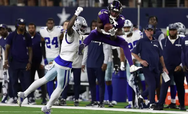 Baltimore Ravens wide receiver Zay Flowers (4) catches a pass as Dallas Cowboys cornerback Trevon Diggs (7) defends late in the second half of an NFL football game in Arlington, Texas, Sunday, Sept. 22, 2024. (AP Photo/Gareth Patterson)