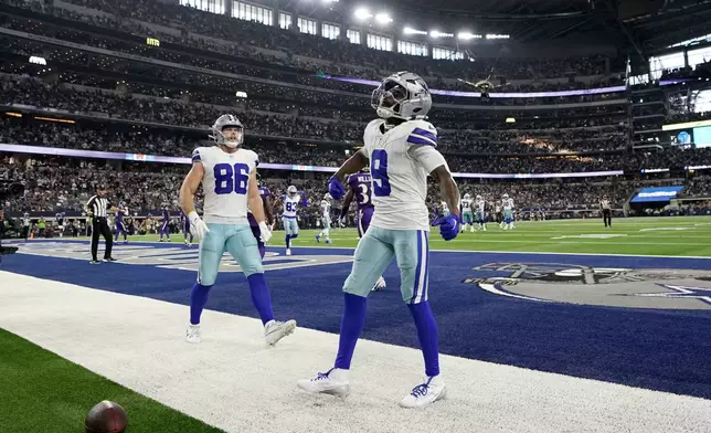 Dallas Cowboys wide receiver KaVontae Turpin (9) celebrates after catching a touchdown pass as tight end Luke Schoonmaker (86) looks on in the second half of an NFL football game against the Baltimore Ravens in Arlington, Texas, Sunday, Sept. 22, 2024. (AP Photo/Jeffrey McWhorter)