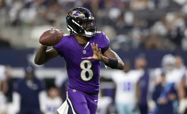 Baltimore Ravens quarterback Lamar Jackson (8) throws a touchdown pass to wide receiver Rashod Bateman in the first half of an NFL football game against the Dallas Cowboys in Arlington, Texas, Sunday, Sept. 22, 2024. (AP Photo/Gareth Patterson)