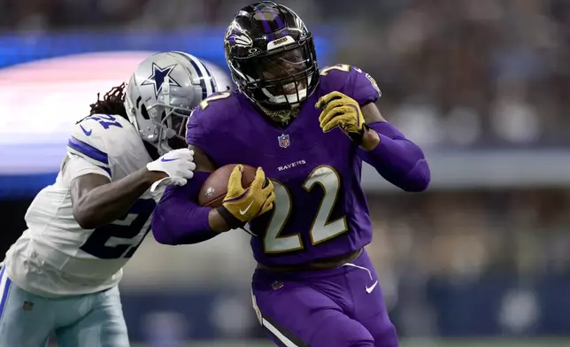 Baltimore Ravens running back Derrick Henry (22) rushes for a touchdown as Dallas Cowboys' Caelen Carson (21) defends in the second half of an NFL football game in Arlington, Texas, Sunday, Sept. 22, 2024. (AP Photo/Gareth Patterson)