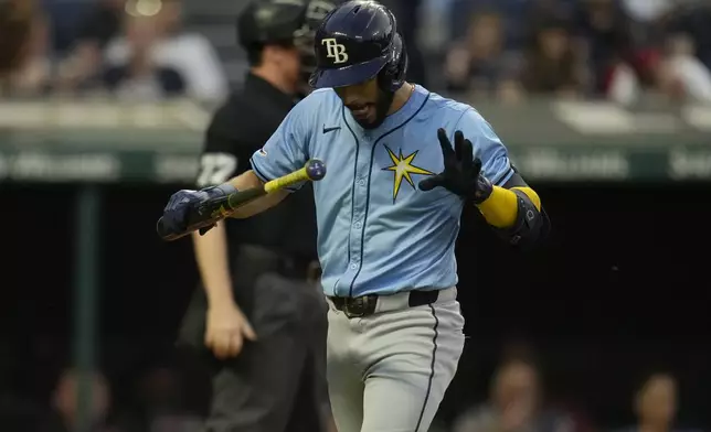 Tampa Bay Rays' Jose Caballero walks back to the dugout after striking out in the second inning of a baseball game against the Cleveland Guardians, Friday, Sept. 13, 2024, in Cleveland. (AP Photo/Sue Ogrocki)