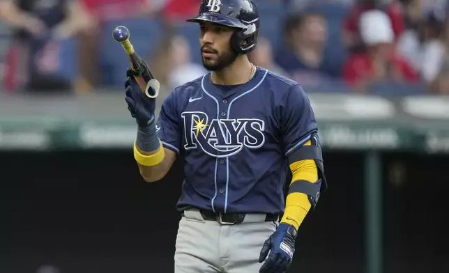 Tampa Bay Rays' Jose Caballero tosses his bat after striking out in the fourth inning of a baseball game against the Cleveland Guardians, Saturday, Sept. 14, 2024, in Cleveland. (AP Photo/Sue Ogrocki)