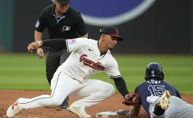 Tampa Bay Rays' Josh Lowe (15) steals second base under a tag by Cleveland Guardians second baseman Andres Gimenez, front left, in the fifth inning of a baseball game Saturday, Sept. 14, 2024, in Cleveland. (AP Photo/Sue Ogrocki)