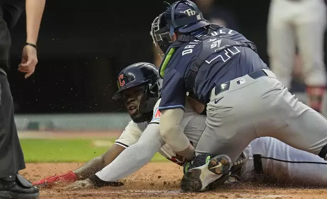 Cleveland Guardians' Jhonkensy Noel, left, is tagged out at home plate by Tampa Bay Rays catcher Logan Driscoll, right, in the fifth inning of a baseball game, Saturday, Sept. 14, 2024, in Cleveland. (AP Photo/Sue Ogrocki)