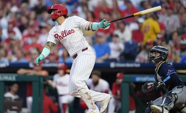 Philadelphia Phillies' Nick Castellanos watches his two run home run off Tampa Bay Rays' Shane Baz during the first inning of a baseball game, Wednesday, Sept. 11, 2024, in Philadelphia. (AP Photo/Derik Hamilton)