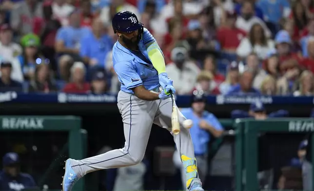 Tampa Bay Rays' Junior Caminero hits an RBI single off Philadelphia Phillies' Ranger Suarez during the fifth inning of a baseball game, Tuesday, Sept. 10, 2024, in Philadelphia. (AP Photo/Derik Hamilton)