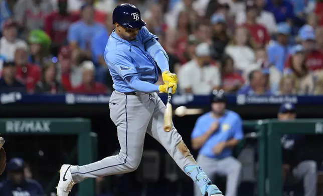 Tampa Bay Rays' Christopher Morel hits a RBI triple off Philadelphia Phillies' Ranger Suárez during the sixth inning of a baseball game, Tuesday, Sept. 10, 2024, in Philadelphia. (AP Photo/Derik Hamilton)