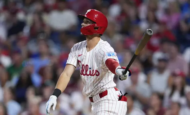 Philadelphia Phillies' Trea Turner watches his two-run home run off Tampa Bay Rays' Taj Bradley during the third inning of a baseball game, Tuesday, Sept. 10, 2024, in Philadelphia. (AP Photo/Derik Hamilton)