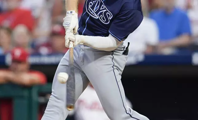 Tampa Bay Rays' Taylor Walls hits an RBI single off Philadelphia Phillies' Zack Wheeler during the second inning of a baseball game, Wednesday, Sept. 11, 2024, in Philadelphia. (AP Photo/Derik Hamilton)