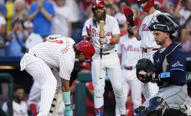 Philadelphia Phillies' Nick Castellanos, left, celebrates after hitting a two run home run off Tampa Bay Rays' Shane Baz during the first inning of a baseball game, Wednesday, Sept. 11, 2024, in Philadelphia. (AP Photo/Derik Hamilton)