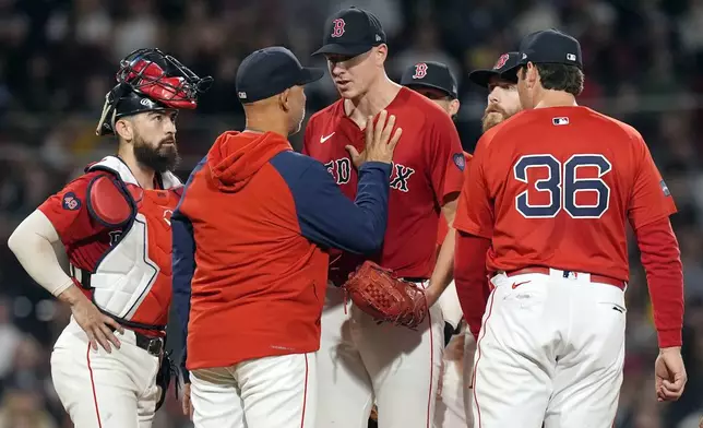 Boston Red Sox manager Alex Cora, center left, relieves starting pitcher Nick Pivetta, center right, during the seventh inning of a baseball game against the Tampa Bay Rays, Friday, Sept. 27, 2024, in Boston. (AP Photo/Michael Dwyer)