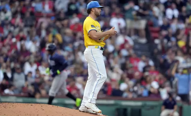 Boston Red Sox starting pitcher Kutter Crawford stands on the mound after giving up a two-run home run to Junior Caminero that also drove in Yandy Díaz, left, during the third inning of a baseball game, Saturday, Sept. 28, 2024, in Boston. (AP Photo/Michael Dwyer)