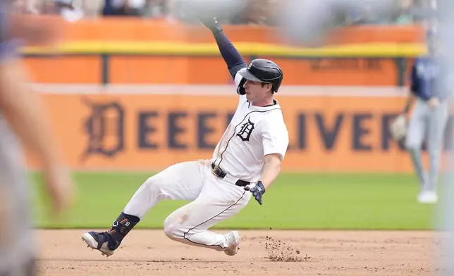 Detroit Tigers' Colt Keith slides for a RBI triple during the sixth inning of a baseball game against the Tampa Bay Rays, Thursday, Sept. 26, 2024, in Detroit. (AP Photo/Carlos Osorio)