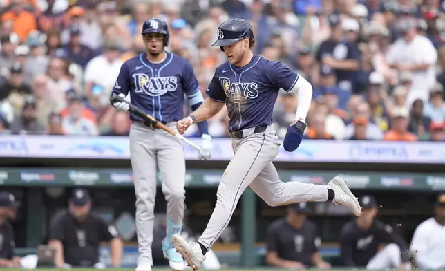 Tampa Bay Rays' Taylor Walls reaches home plate to score on a wild pitch during the fifth inning of a baseball game against the Detroit Tigers, Thursday, Sept. 26, 2024, in Detroit. (AP Photo/Carlos Osorio)