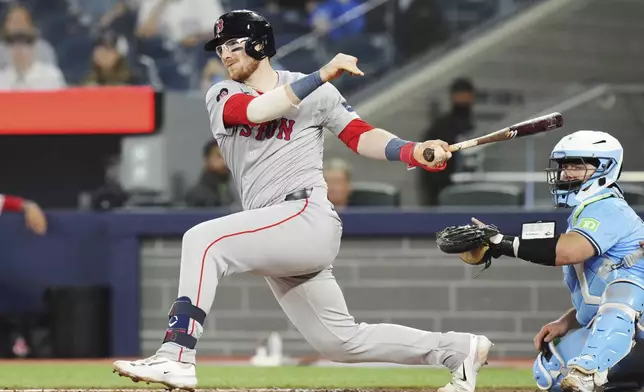 Boston Red Sox's Danny Jansen (28) grounds out as Toronto Blue Jays catcher Alejandro Kirk (30) looks on during the third inning of a baseball game in Toronto, Tuesday, Sept. 24, 2024. (Chris Young/The Canadian Press via AP)