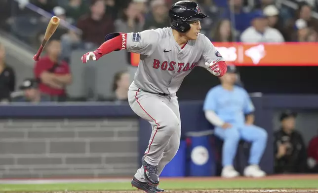 Boston Red Sox's Masataka Yoshida grounds into a fielder's choice scoring a run during the eighth inning of a baseball game against the Toronto Blue Jays in Toronto, Tuesday, Sept. 24, 2024. (Chris Young/The Canadian Press via AP)