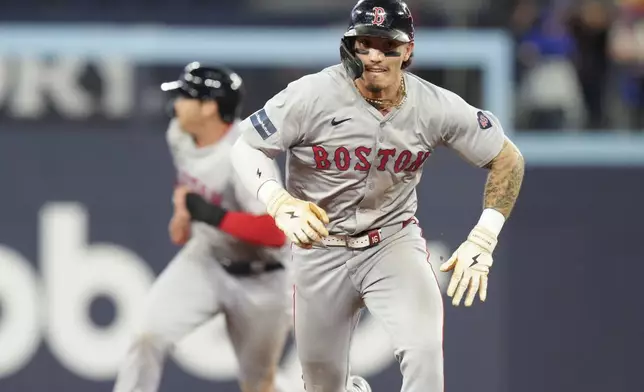 Boston Red Sox's Jarren Duran rounds the bases to score a run on a Trevor Story RBI double against the Toronto Blue Jays during the 10th inning of a baseball game in Toronto, Tuesday, Sept. 24, 2024. (Chris Young/The Canadian Press via AP)