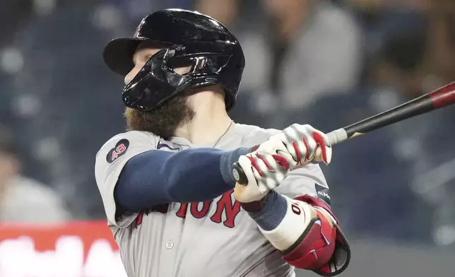 Boston Red Sox's Trevor Story hits a go-ahead RBI double during the 10th inning of a baseball game against the Toronto Blue Jays in Toronto, Tuesday, Sept. 24, 2024. (Chris Young/The Canadian Press via AP)