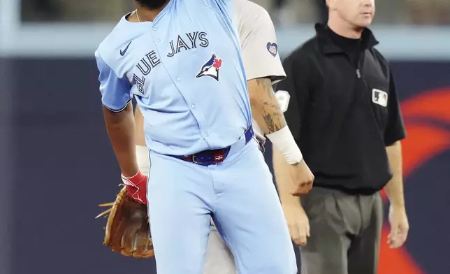 Toronto Blue Jays' Vladimir Guerrero Jr. (27) celebrates his two-run double against the Boston Red Sox during the third inning of a baseball game in Toronto, Tuesday, Sept. 24, 2024. (Chris Young/The Canadian Press via AP)