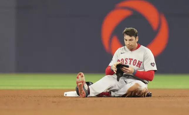 Boston Red Sox' Triston Casas sits at second base after being tagged out in a double play during the fourth inning of a baseball action against the Toronto Blue Jays in Toronto, Tuesday, Sept. 24, 2024. (Chris Young/The Canadian Press via AP)