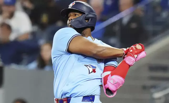 Toronto Blue Jays' Vladimir Guerrero Jr. (27) hits a two-run double against the Boston Red Sox during the third inning of a baseball game in Toronto, Tuesday, Sept. 24, 2024. (Chris Young/The Canadian Press via AP)