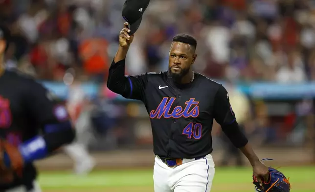 New York Mets pitcher Luis Severino tips his cap to fans on his way to the dugout during the seventh inning of a baseball game against the Boston Red Sox, Monday, Sept. 2, 2024, in New York. (AP Photo/Noah K. Murray)