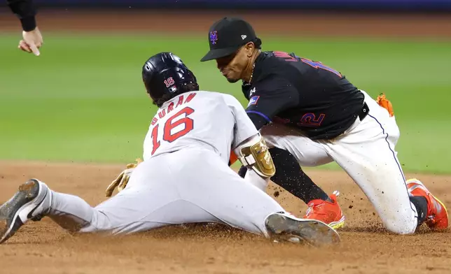 New York Mets shortstop Francisco Lindor, right, tags out Boston Red Sox' Jarren Duran (16) during the third inning of a baseball game, Monday, Sept. 2, 2024, in New York. (AP Photo/Noah K. Murray)