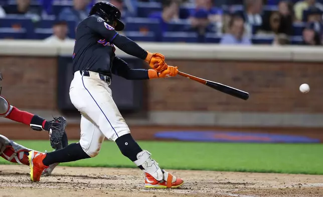 New York Mets' Francisco Lindor hits an RBI single against the Boston Red Sox during the fourth inning of a baseball game, Monday, Sept. 2, 2024, in New York. (AP Photo/Noah K. Murray)