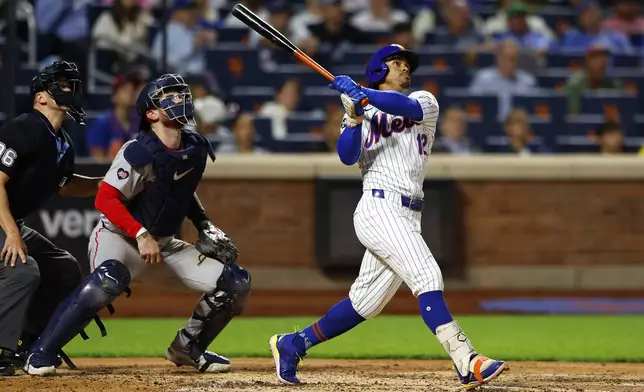 New York Mets shortstop Francisco Lindor (12) follows through on his two run home run against the Boston Red Sox during the third inning of a baseball game, Tuesday, Sept. 3, 2024, in New York. (AP Photo/Noah K. Murray)