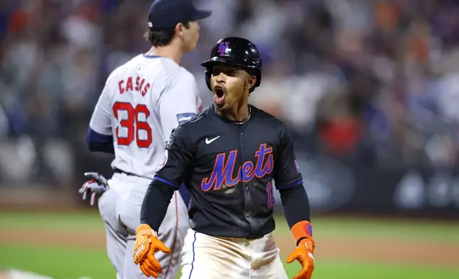 New York Mets' Francisco Lindor (12) reacts after hitting an RBI single against the Boston Red Sox during the fourth inning of a baseball game, Monday, Sept. 2, 2024, in New York. (AP Photo/Noah K. Murray)