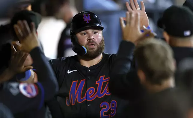 New York Mets' DJ Stewart celebrates in the dugout after scoring against the Boston Red Sox during the fourth inning of a baseball game, Monday, Sept. 2, 2024, in New York. (AP Photo/Noah K. Murray)