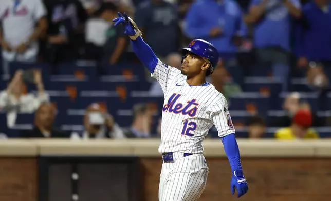 New York Mets' Francisco Lindor reacts after hitting a two run home run against the Boston Red Sox during the third inning of a baseball game, Tuesday, Sept. 3, 2024, in New York. (AP Photo/Noah K. Murray)