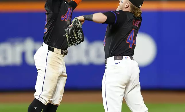 New York Mets' Francisco Lindor, left, and Harrison Bader celebrate after defeating the Boston Red Sox, Monday, Sept. 2, 2024, in New York. (AP Photo/Noah K. Murray)