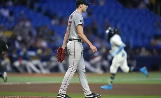 Boston Red Sox starting pitcher Nick Pivetta reacts as Tampa Bay Rays' Junior Caminero runs around the bases following his solo home run during the fourth inning of a baseball game Tuesday, Sept. 17, 2024, in St. Petersburg, Fla. (AP Photo/Chris O'Meara)