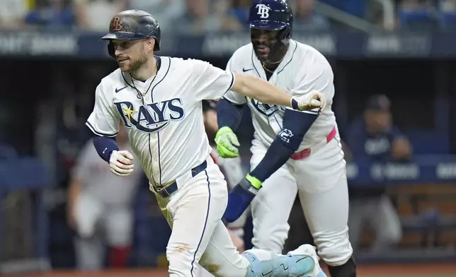 Tampa Bay Rays' Brandon Lowe, left, celebrates with Yandy Diaz after Lowe hit a two-run home run off Boston Red Sox relief pitcher Bailey Horn during the fifth inning of a baseball game Tuesday, Sept. 17, 2024, in St. Petersburg, Fla. (AP Photo/Chris O'Meara)