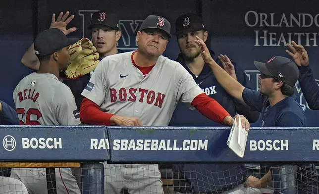 Boston Red Sox starting pitcher Brayan Bello (66) celebrates with teammates after being taken out of the game against the Tampa Bay Rays during the sixth inning of a baseball game Thursday, Sept. 19, 2024, in St. Petersburg, Fla. (AP Photo/Chris O'Meara)