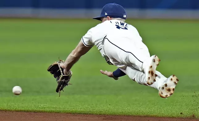 Tampa Bay Rays second baseman Brandon Lowe dives but can't get to a single by Boston Red Sox's Wilyer Abreu during the fifth inning of a baseball game Tuesday, Sept. 17, 2024, in St. Petersburg, Fla. (AP Photo/Chris O'Meara)