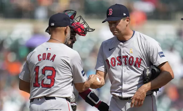 Boston Red Sox manager Alex Cora (13) takes the ball from pitcher Rich Hill against the Detroit Tigers in the fifth inning of a baseball game, Sunday, Sept. 1, 2024, in Detroit. (AP Photo/Paul Sancya)