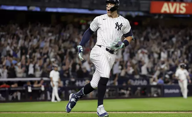 New York Yankees' Aaron Judge reacts after hitting a grand slam during the seventh inning of a baseball game at bat Friday, Sept. 13, 2024, in New York. (AP Photo/Adam Hunger)