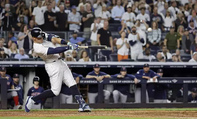 New York Yankees' Aaron Judge hits a grand slam during the seventh inning of a baseball game at bat Friday, Sept. 13, 2024, in New York. (AP Photo/Adam Hunger)