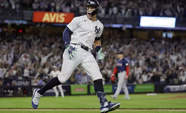 New York Yankees' Aaron Judge reacts after hitting a grand slam off Boston Red Sox relief pitcher Cam Booser during the seventh inning of a baseball game Friday, Sept. 13, 2024, in New York. (AP Photo/Adam Hunger)