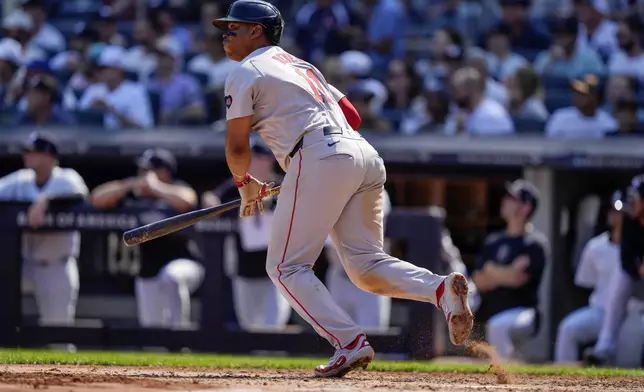 Boston Red Sox's Rafael Devers runs to first base for a two-run single during the fifth inning of a baseball game against the New York Yankees, Saturday, Sept. 14, 2024, in New York. (AP Photo/Frank Franklin II)